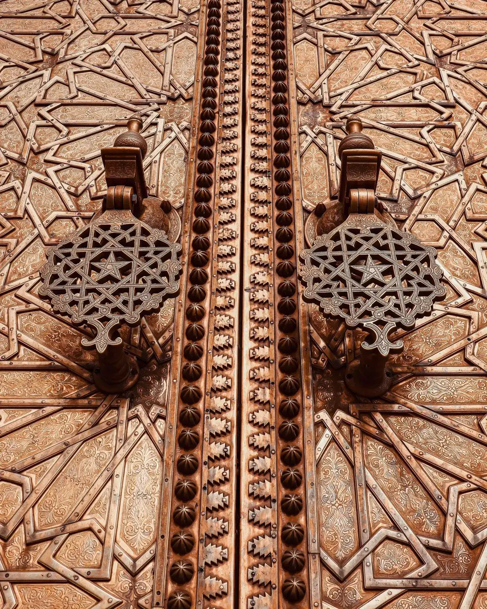 Detail of hand-cast brass door knockers with star motifs